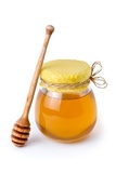 Honey jar with honeycomb lid and wooden spoon